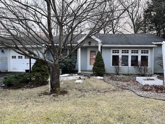 ranch-style house with a garage and a front yard