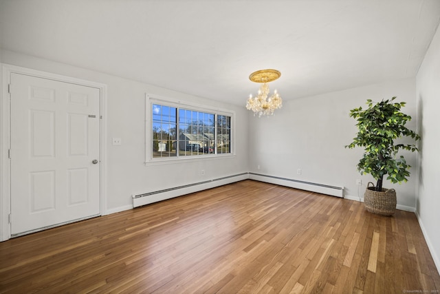 interior space with baseboard heating, a chandelier, and hardwood / wood-style flooring