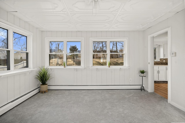 unfurnished sunroom featuring a baseboard radiator