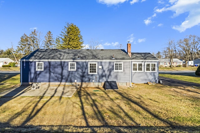 rear view of property with a lawn