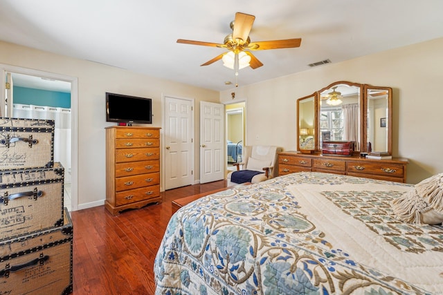 bedroom featuring dark wood-type flooring, connected bathroom, and ceiling fan