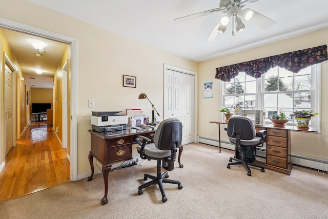 carpeted office space featuring ceiling fan