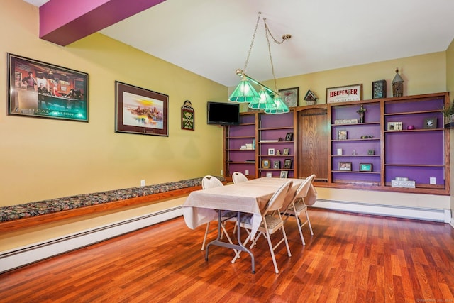 dining room with a baseboard heating unit and dark wood-type flooring