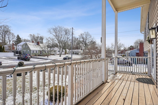 snow covered deck featuring a porch