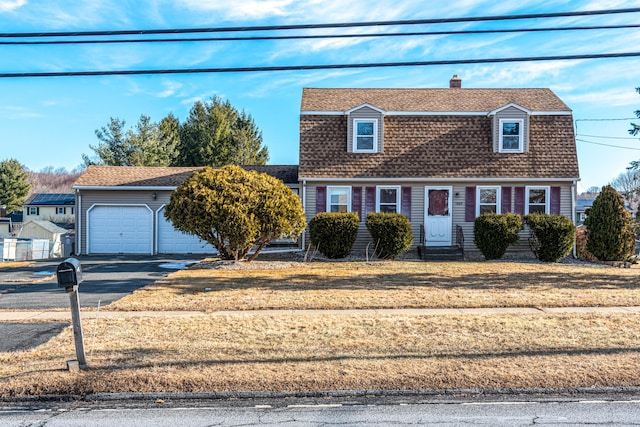 view of front of property with a front yard and a garage