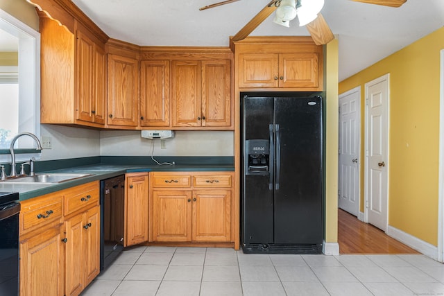 kitchen featuring ceiling fan, light tile patterned floors, sink, and black appliances