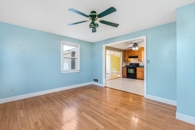 unfurnished living room with ceiling fan and light hardwood / wood-style flooring