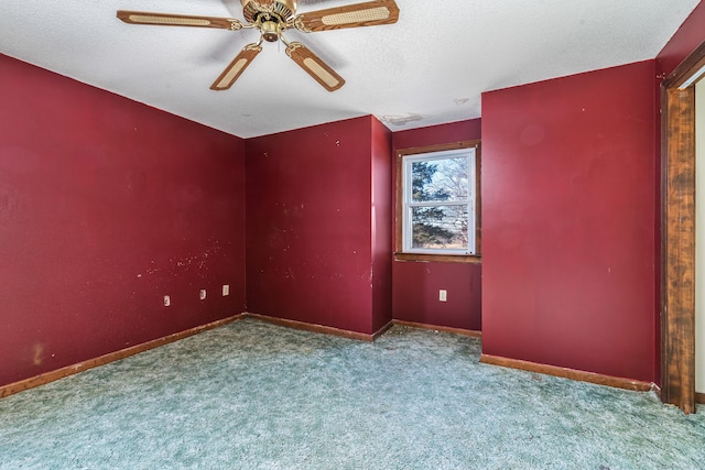 carpeted empty room featuring ceiling fan and a textured ceiling