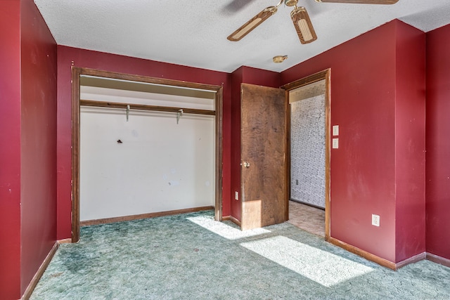 unfurnished bedroom with a textured ceiling, ceiling fan, a closet, and light colored carpet