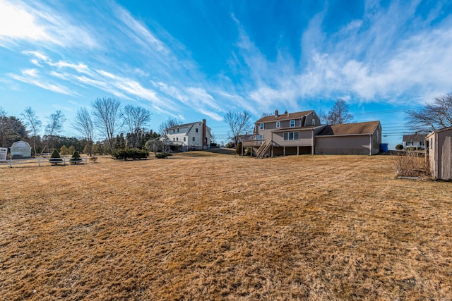 view of yard with a deck and a storage shed