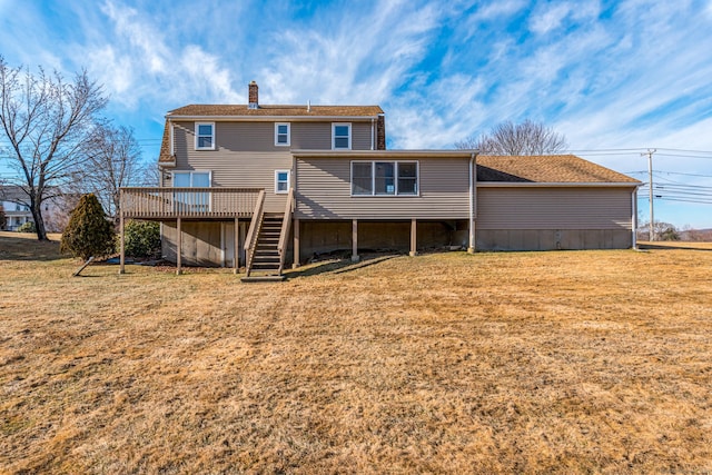 rear view of property with a deck and a yard