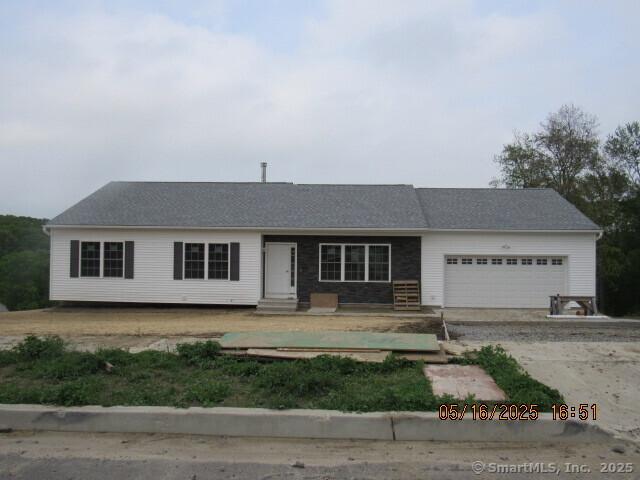 ranch-style house featuring a garage, entry steps, and driveway
