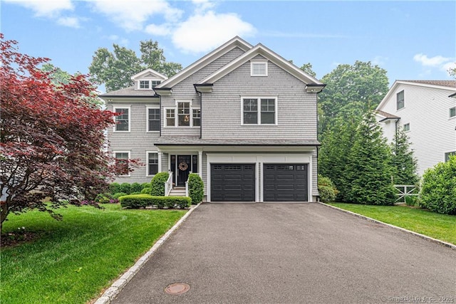 view of front of home featuring a garage and a front lawn