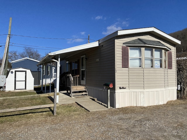 view of property exterior featuring a storage unit