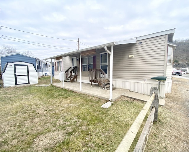 view of front of house featuring a front yard and a storage shed