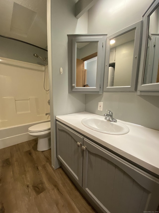 full bathroom featuring vanity, toilet, hardwood / wood-style floors, and shower / bathing tub combination