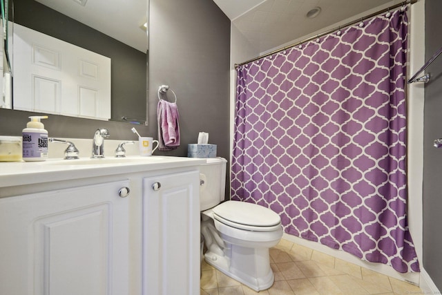 bathroom with tile patterned flooring, vanity, and toilet