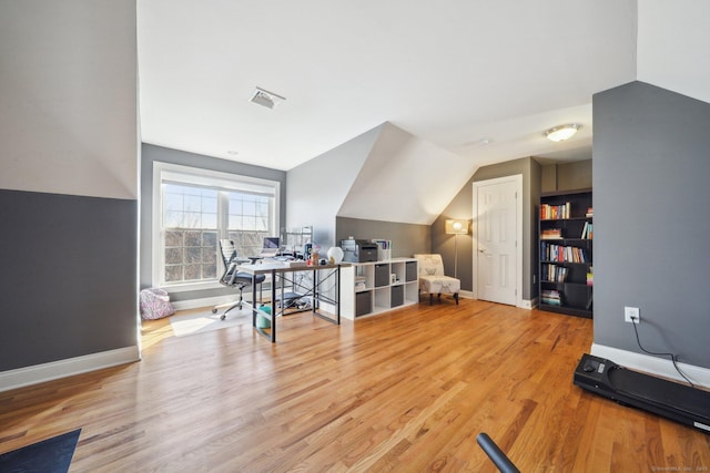 interior space with lofted ceiling and wood-type flooring