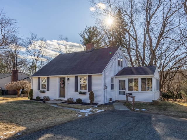 view of front of house featuring a front yard and a sunroom