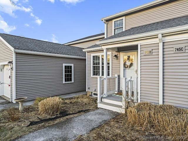 doorway to property with a garage