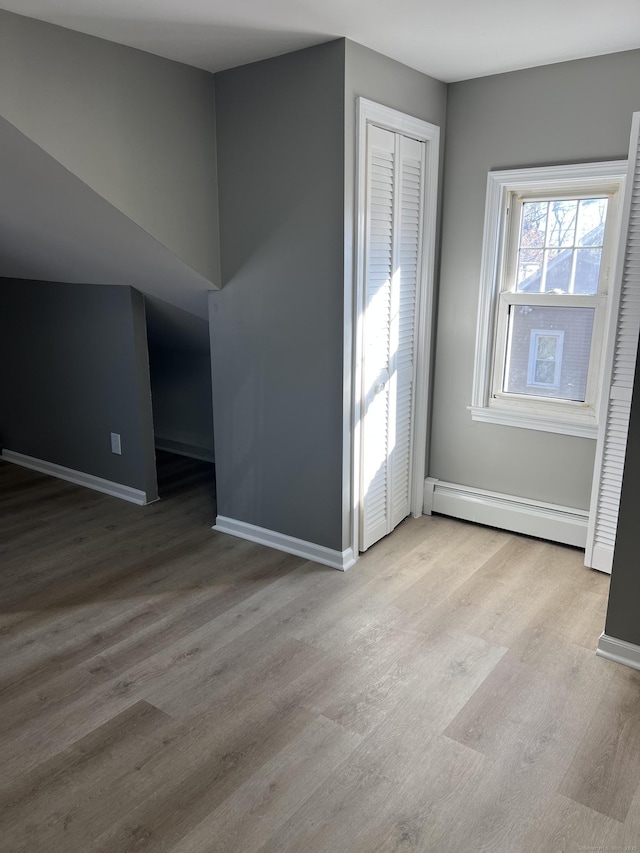 interior space with light hardwood / wood-style floors and a baseboard radiator