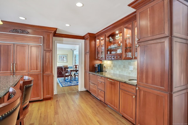 bar featuring light wood finished floors, decorative backsplash, and recessed lighting