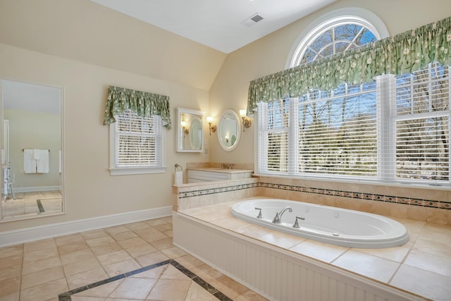 full bath with baseboards, visible vents, lofted ceiling, tile patterned floors, and a garden tub