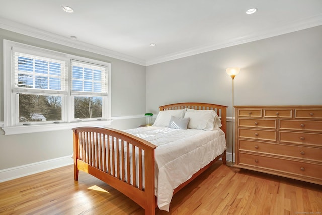 bedroom with ornamental molding, recessed lighting, light wood-style flooring, and baseboards