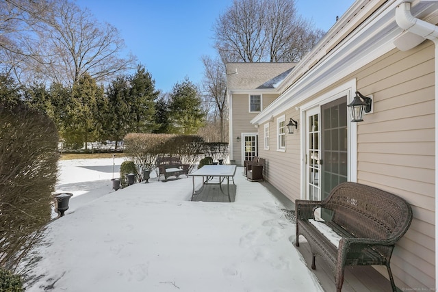 snow covered patio with outdoor dining area