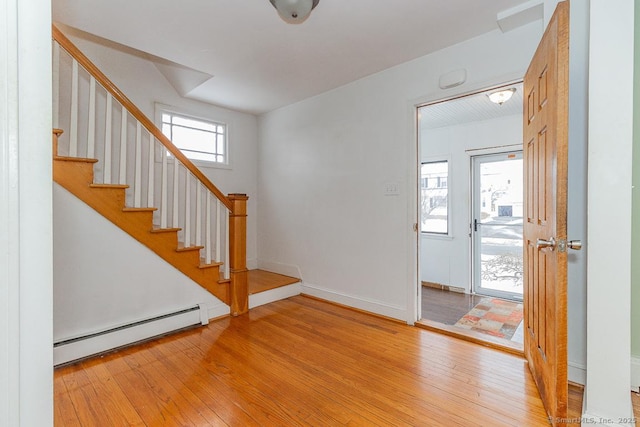 entryway with light hardwood / wood-style floors and baseboard heating