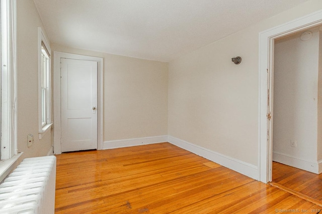 empty room with hardwood / wood-style floors