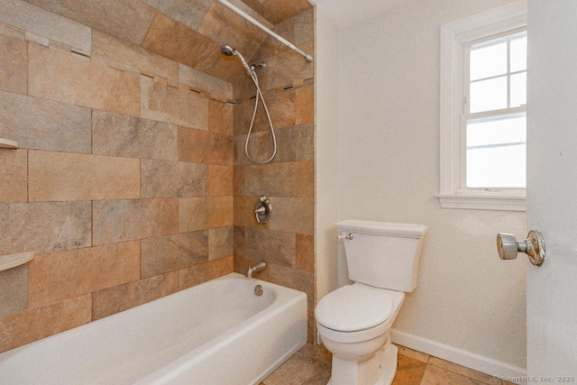 bathroom featuring tiled shower / bath and toilet