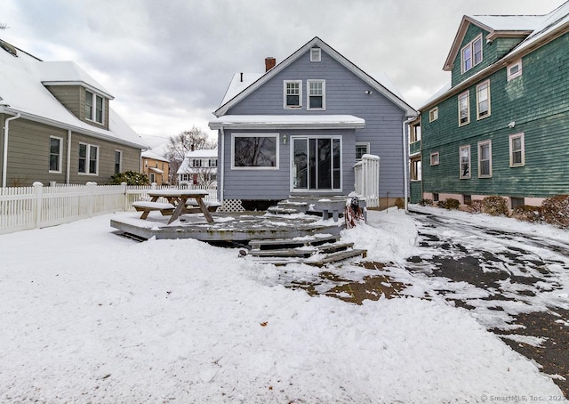 view of snow covered rear of property