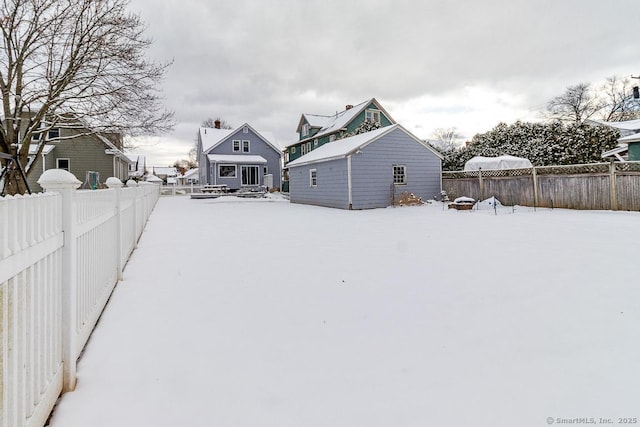 yard layered in snow with an outdoor structure