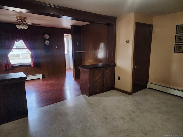 kitchen with a baseboard heating unit, ceiling fan, and beamed ceiling