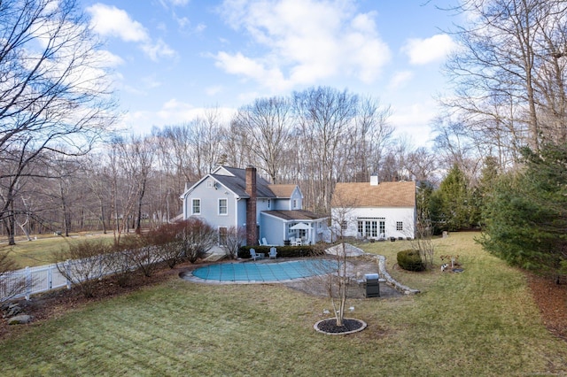 back of house featuring a patio area, a yard, and french doors