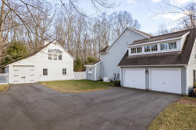 view of side of property with a garage and a yard