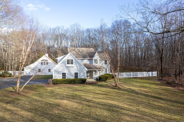 new england style home featuring a front lawn