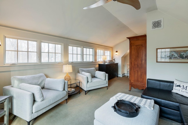 living room with ceiling fan, light colored carpet, and vaulted ceiling