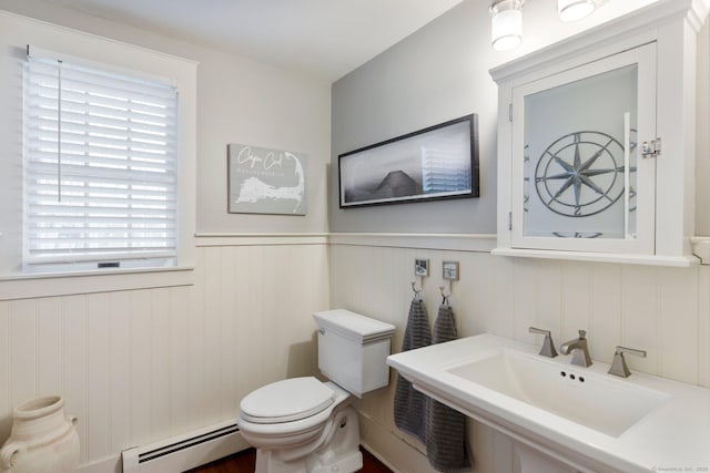 bathroom with a baseboard radiator, toilet, and sink