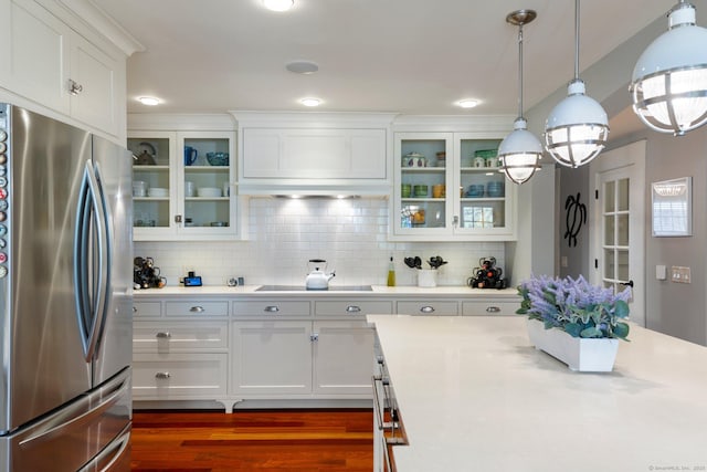 kitchen featuring decorative light fixtures, white cabinetry, stainless steel refrigerator, and black electric cooktop