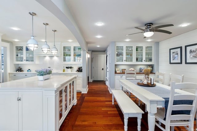 kitchen with white cabinetry, a center island, tasteful backsplash, dark hardwood / wood-style floors, and pendant lighting