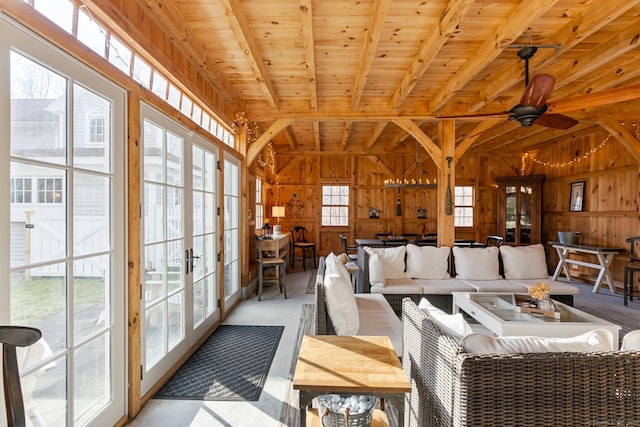 sunroom / solarium with vaulted ceiling with beams, ceiling fan, french doors, and wooden ceiling