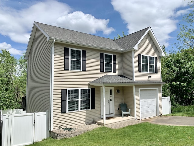 view of front of property featuring a garage and a front lawn