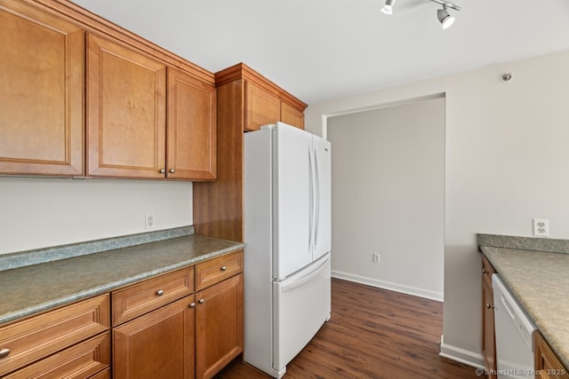 kitchen with white appliances and dark wood-type flooring