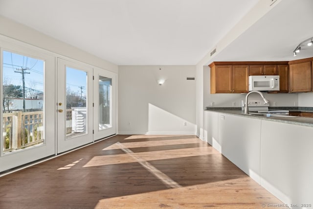 kitchen featuring hardwood / wood-style flooring, range, and french doors