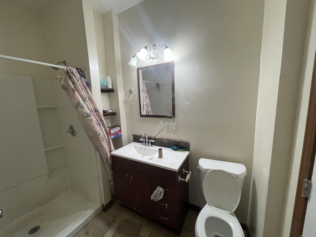 bathroom featuring tile patterned flooring, vanity, toilet, and curtained shower