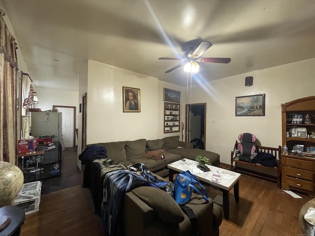 living room with ceiling fan and dark hardwood / wood-style flooring