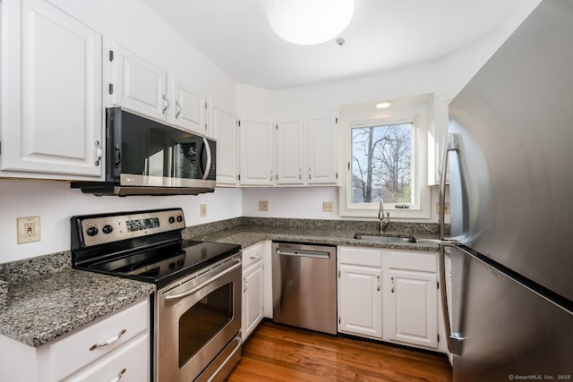 kitchen featuring stainless steel appliances, white cabinets, and sink