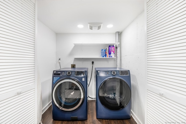 clothes washing area featuring washer and dryer and dark hardwood / wood-style flooring